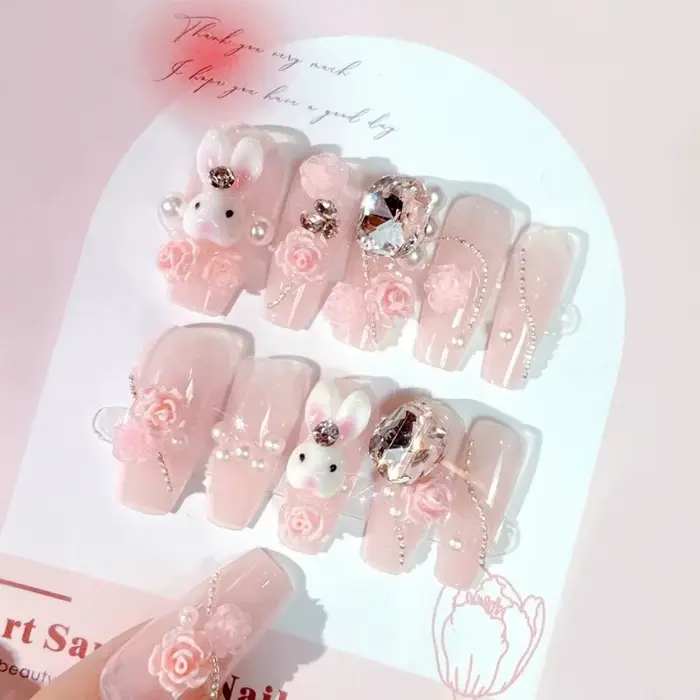 Faux ongles rose poudré avec nœud