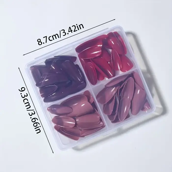 96 ongles en amande faits à la main. Couleur unie en 4 tons : rouge bordeaux, rouge vif, beige nude et marron chocolat. Réutilisable, style classique
