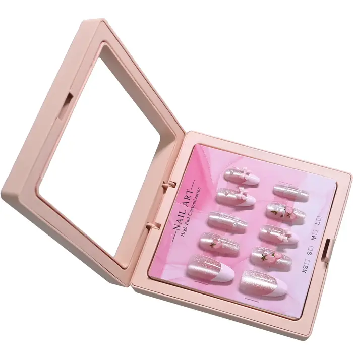 10 ongles d'amande faits à la main dans un étui rose miroir. Base nude pailletée avec motif français blanc